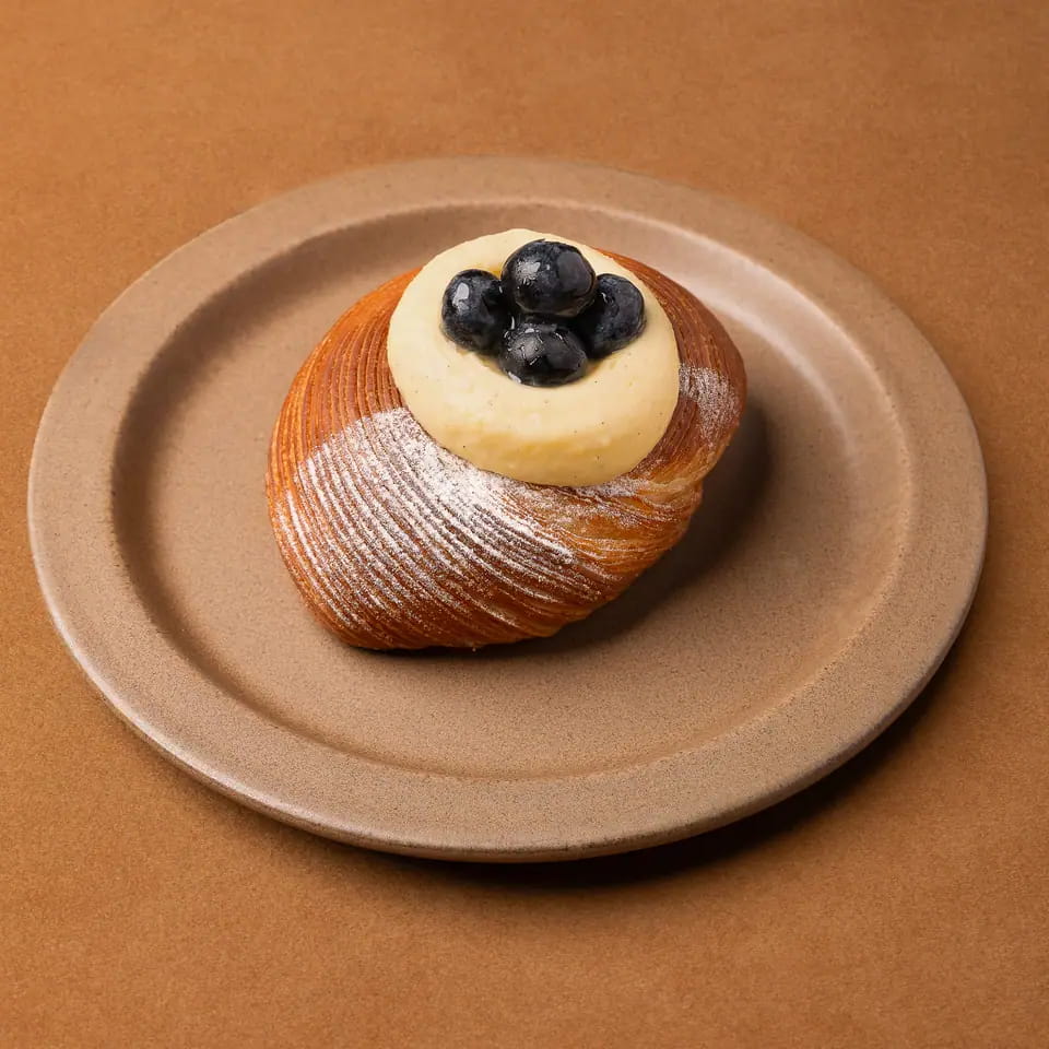 Laminated custard danish topped with blueberries