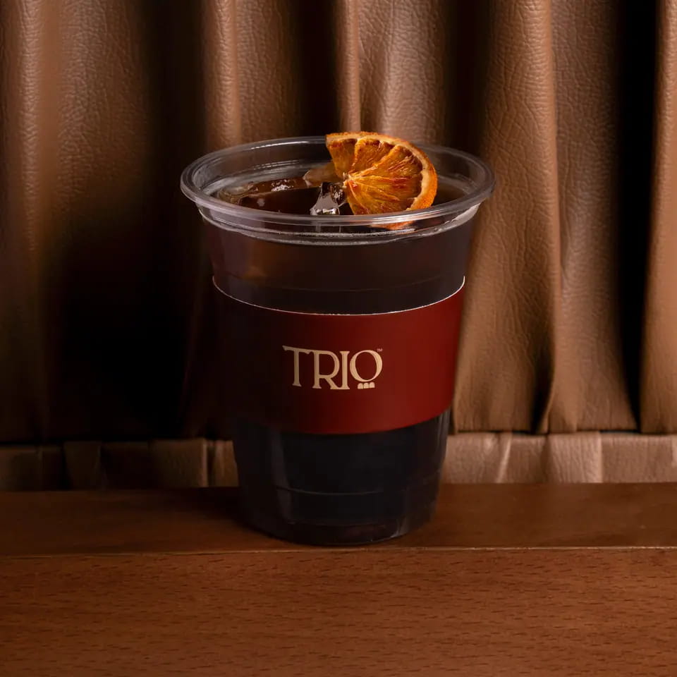 Iced cascara with dried orange in a TRIO takeaway cup