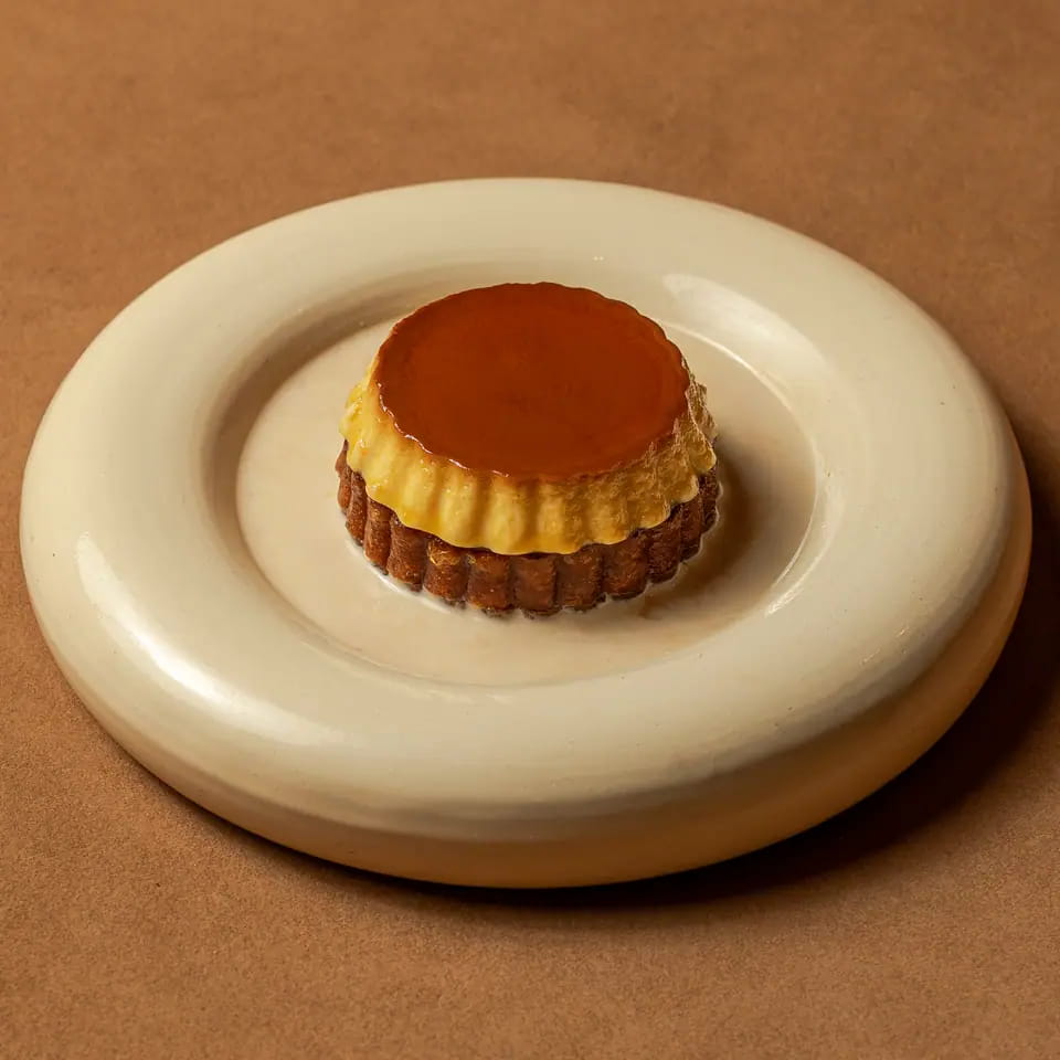 Cream caramel toast with caramel top on a cream ring plate