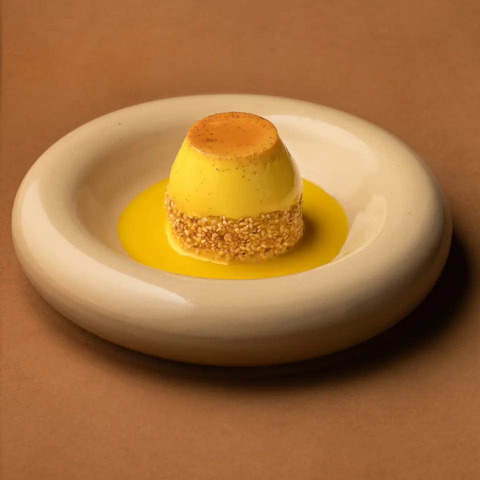 Elba gers ogaily, saffron custard over sponge on a cream ring plate