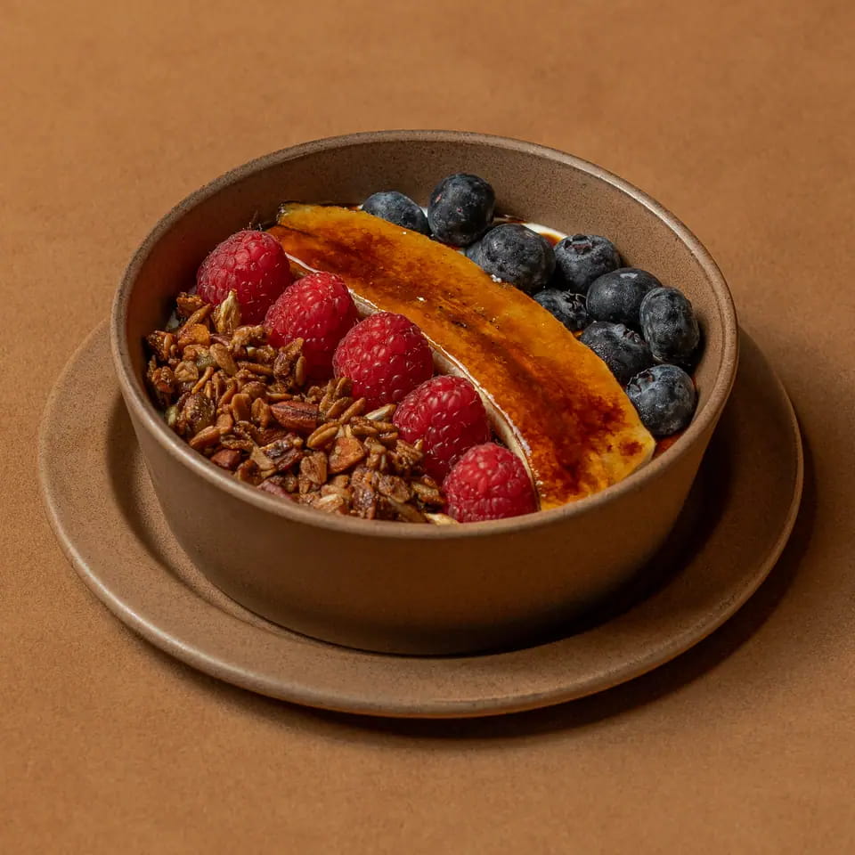 Granola bowl with berries and caramelised banana