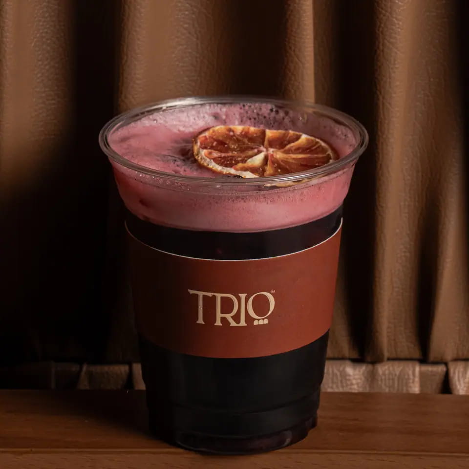Iced hibiscus with dried orange in a TRIO takeaway cup
