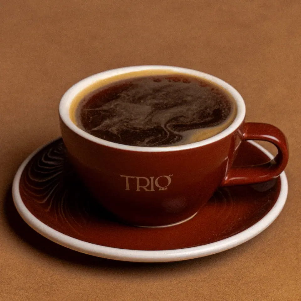 Long black in a burgundy TRIO cup