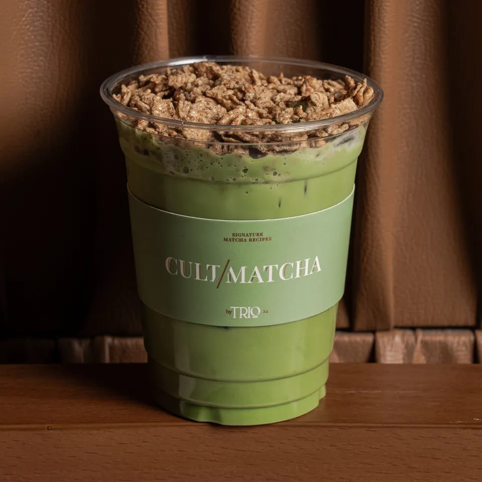 Malty cereal matcha topped with cereal crumble in a Cult Matcha cup