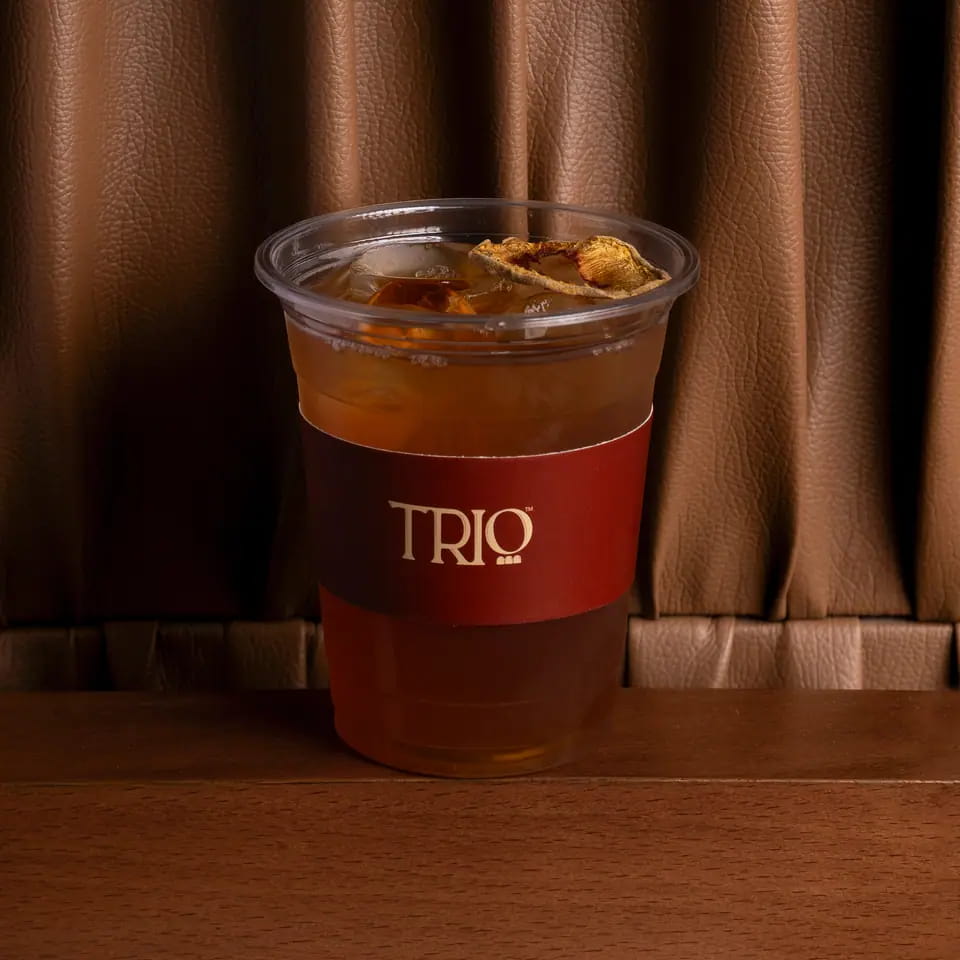 Peach iced tea in a TRIO takeaway cup