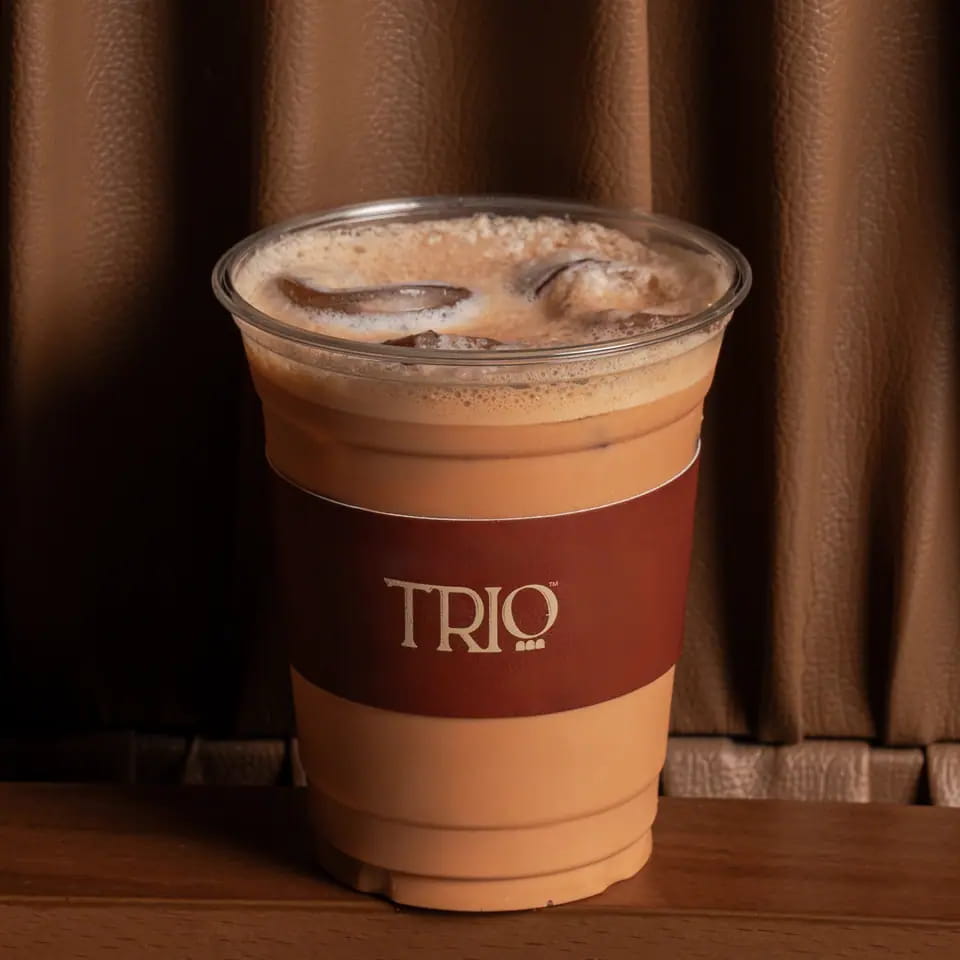 Iced Thai tea latte in a TRIO takeaway cup
